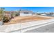View of the side of the house featuring white paint, clean concrete and an arid landscape at 6204 Parsifal Pl, Las Vegas, NV 89107