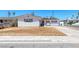 Charming single-story home featuring a clean white exterior with brown window shutters and a well-maintained lawn at 6204 Parsifal Pl, Las Vegas, NV 89107