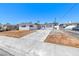 Single-story home boasts a concrete driveway and a bright, white exterior paint at 6204 Parsifal Pl, Las Vegas, NV 89107