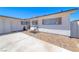 The exterior is crisp, white, single-story and features brick and concrete at 6204 Parsifal Pl, Las Vegas, NV 89107