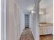 Hallway with built-in storage and an entrance to a bathroom featuring a granite countertop at 6204 Parsifal Pl, Las Vegas, NV 89107