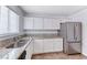 Kitchen featuring stainless steel appliances, granite countertops, and a double sink at 6204 Parsifal Pl, Las Vegas, NV 89107