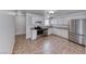 Updated kitchen featuring stainless steel appliances, white cabinets, and granite countertops at 6204 Parsifal Pl, Las Vegas, NV 89107