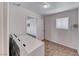 Bright laundry room with tile floor and washer/dryer hookups ready for new appliances to be installed at 6204 Parsifal Pl, Las Vegas, NV 89107