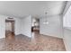 Spacious living room with tiled floors, bright lighting, and access to other rooms at 6204 Parsifal Pl, Las Vegas, NV 89107