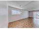 Bright living room with tiled floors, large windows, and modern lighting fixture at 6204 Parsifal Pl, Las Vegas, NV 89107