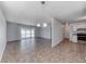 Open living room with tiled floors, access to the kitchen, and sliding glass door at 6204 Parsifal Pl, Las Vegas, NV 89107