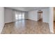 Bright living room featuring tiled floors and seamless access to a patio at 6204 Parsifal Pl, Las Vegas, NV 89107