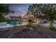 Lush backyard showcasing a pool, covered patio, and mature landscaping, perfect for entertaining at 6245 Galileo Dr, Las Vegas, NV 89149