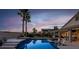 Inviting backyard featuring a pool with spa, covered patio, and desert landscaping at 6245 Galileo Dr, Las Vegas, NV 89149