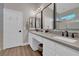 Bright bathroom features dual sinks, modern vanity, quartz counters, and an enclosed shower at 6245 Galileo Dr, Las Vegas, NV 89149
