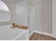 Bathroom with a glass-enclosed shower and soaking tub with storage at 6245 Galileo Dr, Las Vegas, NV 89149