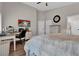 Spacious bedroom with a ceiling fan, an art piece on the wall, and an office work space at 6245 Galileo Dr, Las Vegas, NV 89149