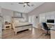 Spacious main bedroom featuring a ceiling fan, views of the backyard, and wood-look flooring at 6245 Galileo Dr, Las Vegas, NV 89149