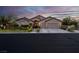 Beautiful single-story home with a well-maintained lawn, a three-car garage and desert landscaping at 6245 Galileo Dr, Las Vegas, NV 89149