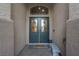Beautiful double door entry featuring decorative glass, sidelights and a seating bench at 6245 Galileo Dr, Las Vegas, NV 89149