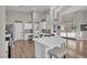 View of the kitchen, which features white cabinets, stainless appliances, and hardwood floors at 6245 Galileo Dr, Las Vegas, NV 89149