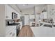 Charming kitchen with white cabinets, stainless appliances, and hardwood floors at 6245 Galileo Dr, Las Vegas, NV 89149