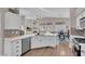 Stylish kitchen with white cabinets, stainless appliances, hardwood floors, and a center island at 6245 Galileo Dr, Las Vegas, NV 89149