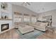 Spacious living room with a fireplace, a large sectional sofa and wood floors at 6245 Galileo Dr, Las Vegas, NV 89149