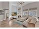 Cozy living room with a stone fireplace, hardwood floors, vaulted ceilings, and neutral paint at 6245 Galileo Dr, Las Vegas, NV 89149