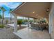 Covered outdoor patio featuring a lounge area, dining area, pool, and desert landscaping at 6245 Galileo Dr, Las Vegas, NV 89149