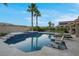 Backyard oasis with inviting pool, sun loungers and lush palm trees at 6245 Galileo Dr, Las Vegas, NV 89149