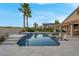 Backyard oasis with inviting pool, sun loungers and lush palm trees at 6245 Galileo Dr, Las Vegas, NV 89149