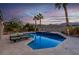 A serene pool with a spa is flanked by palm trees and lounge chairs against a sunset backdrop at 6245 Galileo Dr, Las Vegas, NV 89149