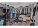 Spacious walk-in closet with ample hanging space, shelving, dresser, and personal safe for secure storage at 6245 Galileo Dr, Las Vegas, NV 89149