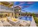 An outdoor oasis with a pool, fire pit, and comfortable seating for relaxing evenings at 6570 Aurora View St, Las Vegas, NV 89135