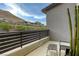 Relaxing balcony area with minimalist furniture, offering views of the surrounding hillside community at 6570 Aurora View St, Las Vegas, NV 89135