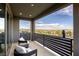 Relaxing balcony with comfortable seating, offering beautiful views of the city and surrounding mountains at 6570 Aurora View St, Las Vegas, NV 89135