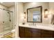 Modern bathroom with glass-enclosed shower, dark cabinets, and a stylish mirror, creating a spa-like atmosphere at 6570 Aurora View St, Las Vegas, NV 89135