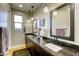 Stylish bathroom showcasing dual sinks with dark countertops, modern lighting, and framed mirrors at 6570 Aurora View St, Las Vegas, NV 89135