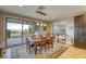 Open dining area with glass sliding doors leading to an outdoor patio with seating and a grill at 6570 Aurora View St, Las Vegas, NV 89135
