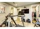Fully-equipped exercise room with treadmill, spin bike, and TV, designed for a comprehensive workout routine at 6570 Aurora View St, Las Vegas, NV 89135