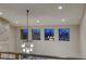 Hallway with modern light fixture and city views visible through the windows at 6570 Aurora View St, Las Vegas, NV 89135