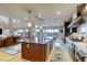 Open kitchen with large island, stainless steel appliances, seamless flow to living and dining areas at 6570 Aurora View St, Las Vegas, NV 89135