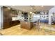 Well-appointed kitchen with dark wood cabinets, stainless steel appliances, and a large center island at 6570 Aurora View St, Las Vegas, NV 89135