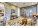 Inviting living room featuring a stone accent wall, hardwood floors and stylish furniture, perfect for relaxation at 6570 Aurora View St, Las Vegas, NV 89135