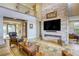Bright living room featuring stone accent wall with fireplace, hardwood floors, and comfortable seating at 6570 Aurora View St, Las Vegas, NV 89135