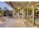 Covered patio features an outdoor kitchen with built-in grill, counter space, and outdoor dining area at 6570 Aurora View St, Las Vegas, NV 89135