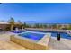 Beautiful pool and spa with lounge chairs, water feature, and lush landscaping at 6570 Aurora View St, Las Vegas, NV 89135