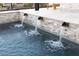 A luxurious backyard pool with water features and an inviting ambiance at 6570 Aurora View St, Las Vegas, NV 89135