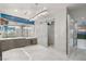 Bright bathroom featuring modern lighting, dual vanities, and a glass enclosed shower at 671 Scenic Rim Dr, Henderson, NV 89012