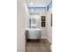 Bathroom featuring modern vanity, wood floors, and unique window providing natural light at 671 Scenic Rim Dr, Henderson, NV 89012