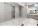 Spacious bathroom with a standalone tub, dual vanity and a glass enclosed shower at 671 Scenic Rim Dr, Henderson, NV 89012