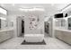 A luxurious bathroom with a modern tub, dual vanities, and access to walk-in closets at 671 Scenic Rim Dr, Henderson, NV 89012