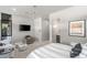 Comfortable and cozy bedroom with a large bed, modern accents, and a lounge chair at 671 Scenic Rim Dr, Henderson, NV 89012